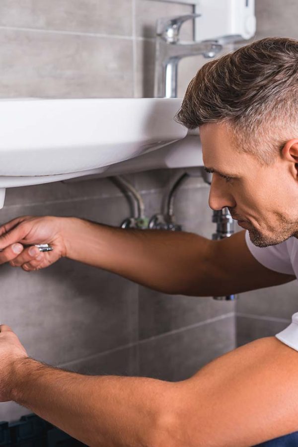 adult-plumber-fixing-sink-at-bathroom-resize.jpg